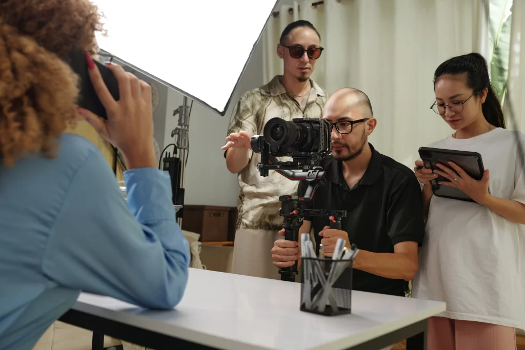 Behind the scenes of a video shoot for content creation, with the production team at work.